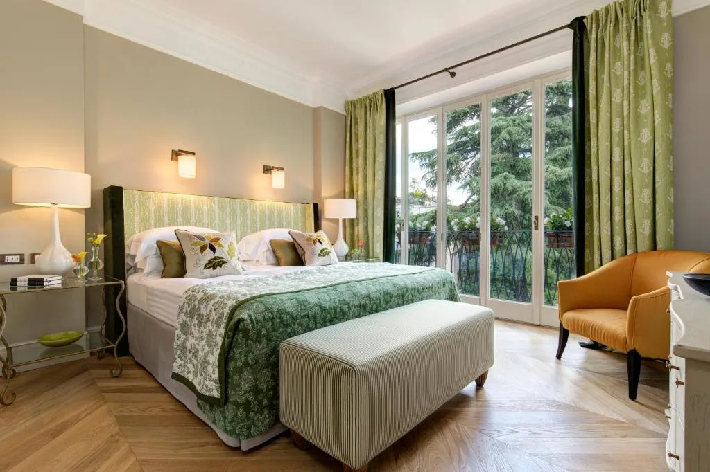 habitación de lujo con cama para dos personas, con un ventanal grande con balcón, donde vas a poder disfrutar de una increíble vista a la ciudad.