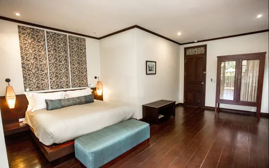 habitación amplia en el hotel the apssara river Droite cuenta una cama para dos personas, buena iluminación, armario y un asiento para una agradable estadía.