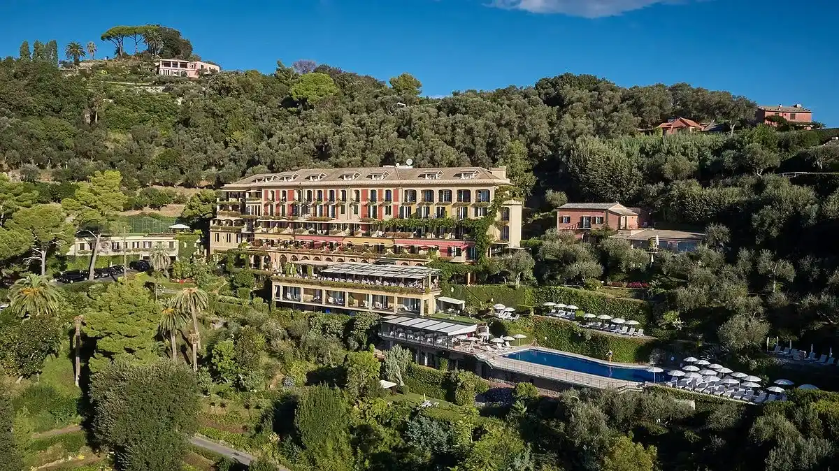 vista panorámica del hotel Splendido, A Belmond donde se puede ver la zona de piscina y otras zonas del hotel rodeado de arboles y zonas verdes.