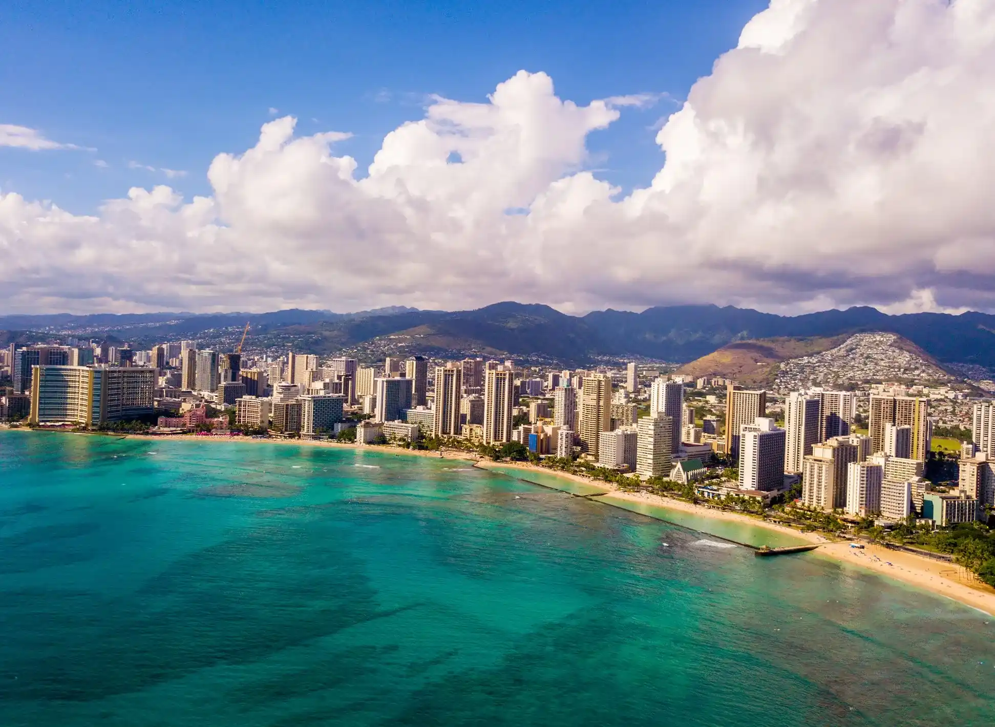 vista panorámica del mar rodeado de edificios y montañas rocosas.